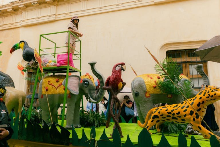 A colorful carnival float featuring animal sculptures in a festive parade.