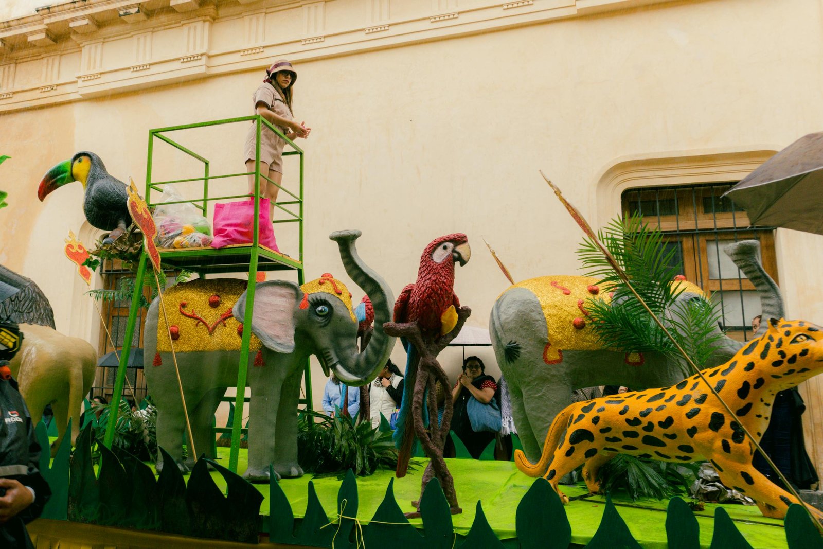 A colorful carnival float featuring animal sculptures in a festive parade.