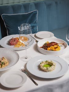 Assorted gourmet dishes elegantly plated on a restaurant table, offering a fine dining experience.