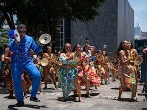 Colorful dancers and musicians celebrate in the streets