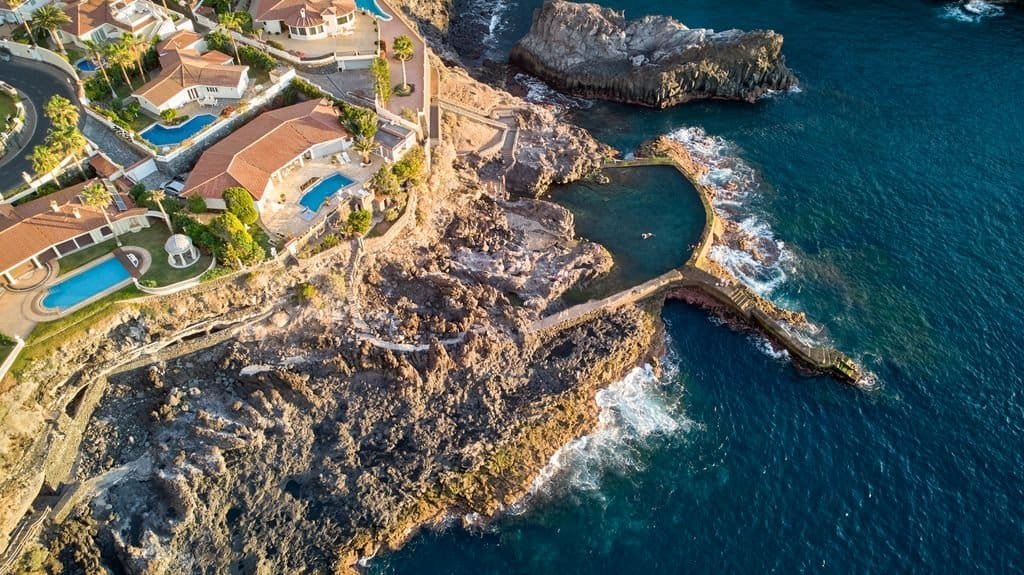 Stunning aerial view of Santiago del Teide's rocky coast and villas.