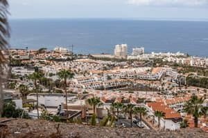 Stunning aerial view of Tenerife's urban landscape meeting the ocean.